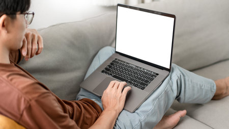 Technology Concept The man that is putting on glasses leaning his back on the dark yellow while...