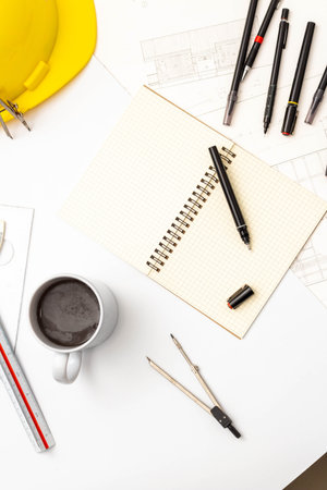 Mockup of architectural concept, Drawing tool and coffee on drawing of blueprint with safety helmet.