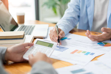Business negotiation concept the female broker estimating the number of estate and checking it with the male broker.の写真素材
