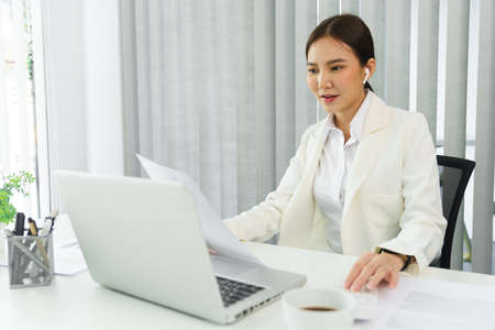 Confidence woman concept, Businesswoman read financial document to calculate cost of business.の写真素材
