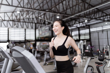 exercise concept The female runner standing and being about to start the treadmill to work on with...