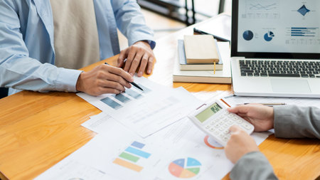 Business negotiation concept the female broker estimating the number of estate and checking it with...