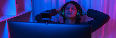 Game stream concept, Male streamer taking a break to rest after live streaming of game tournament.