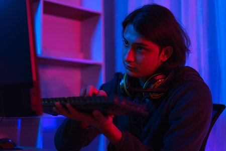 Gamer stream concept, Male streamer typing on keyboard to chat with followers while live stream...