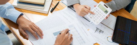 Business negotiation concept the female broker estimating the number of estate and checking it with...