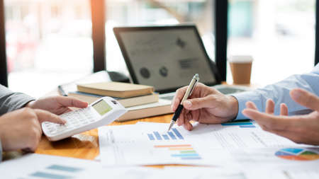 Business negotiation concept the female broker estimating the number of estate and checking it with the male broker.の写真素材