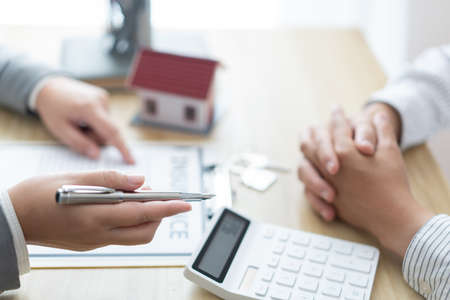 Insurance concept the broker explaining the agreement of the contract to his customer.の写真素材