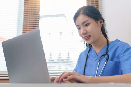 Pet care concept, Female veterinary using laptop for relaxation after examining health pet.の写真素材