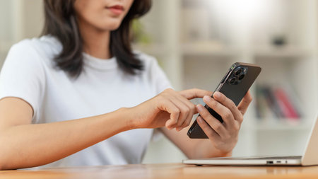 Lifestyle and technology concept, Young Asian woman using smartphone to working online at home
