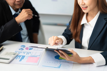 Business partnership concept, Businesswoman pointing at document during senior consultation.の写真素材