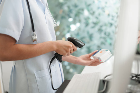Medicine and health concept, Female pharmacist scanning medicine product barcode in cash register.の写真素材