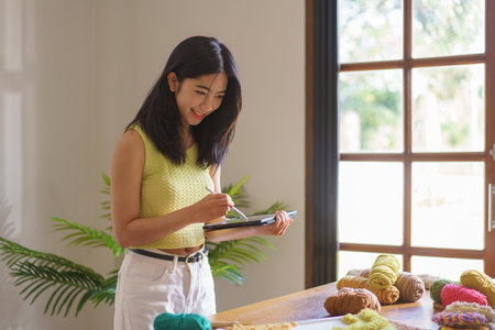 Needlework concept, Women sketches to designing pattern for handicraft embroidery with punch needle.の写真素材