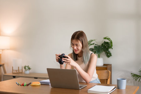 Creative design concept, Fashion designer checking picture in camera of new collection clothes.の写真素材