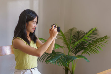 Young asian woman working at home with laptop computer on table.