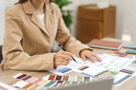 Architecture concept, Female architect selecting color and designing house interior in blueprint.の写真素材