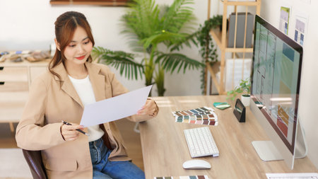 Architectural concept, Female architect holding blueprint and checking of designing house interior.の写真素材
