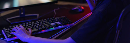 Female cyber hacker gamer in headphones making win gesture after hacking programming system success.の素材