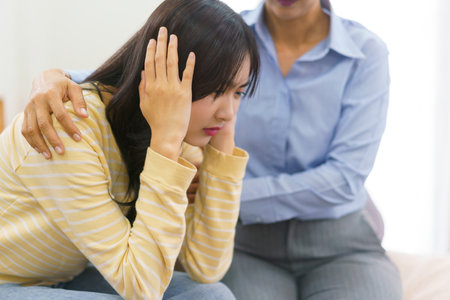 Female psychologist comforting and encourage stressed patient while listening her problem in office.の素材