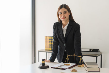 Legal and justice concept, Confident female lawyer standing and smiling while working in law firm.の写真素材