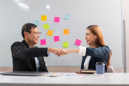 Business partnership concept, Business senior making fist bump with partner after successful work.の写真素材