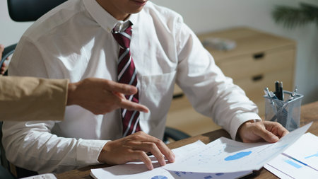 Two business reading business document to discussion and brainstorming about startup at workplace.