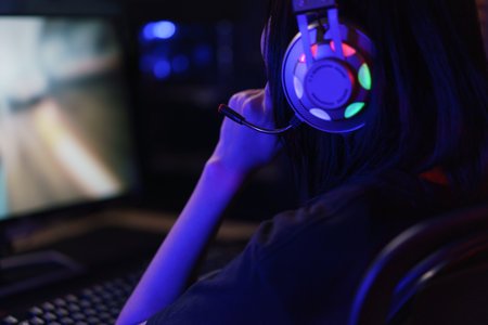 Female cyber hacker gamer in headphone serious face to playing games or hacking programming system.の写真素材