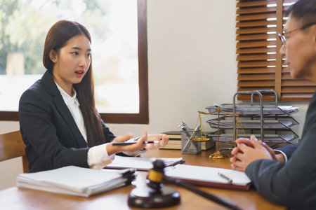 Law and justice concept, Young female lawyer explaining and consulting contract with senior lawyer.