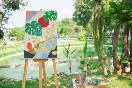 Creative art concept, Art masterpiece in canvas on easel with drawing equipment in the garden.の写真素材