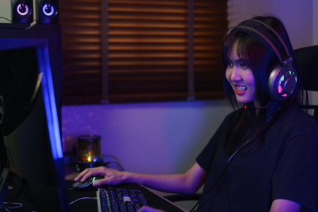 Female cyber hacker gamer in headphone serious face to playing games or hacking programming system.の写真素材