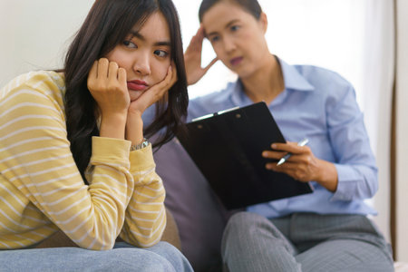 Female patients stressful with mental problem and having session therapy talking with psychologist.の写真素材