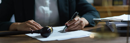 Businesswoman lawyer working and reading agreement business to signing on contract in legal office.