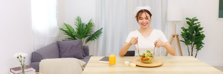 Lifestyle in living room concept, Young Asian woman in glove using cloth to wiping flower vase.の写真素材
