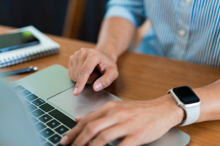 Close up hands of businesswoman typing on laptop keyboard to working and searching business data.の写真素材