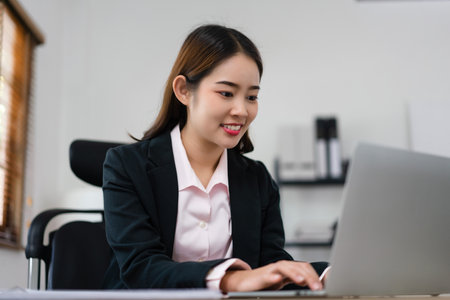 Businesswoman planning for marketing plan of new startup project and typing finance data on laptop.の写真素材