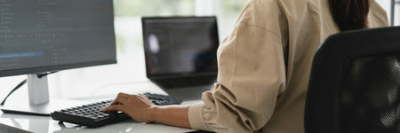 Developer programmer programming code to developing website and application in software office.