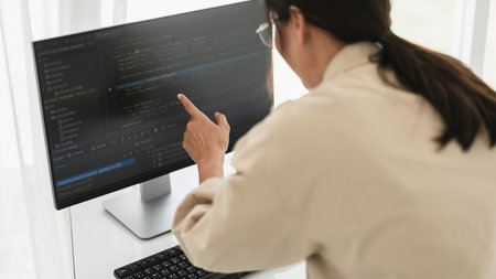 Developer programmer checking code on monitor while programming to developing web and application.
