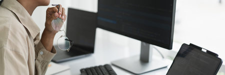 Developer programmer working to checking code on monitor while programming to developing website.