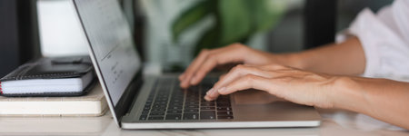 Businesswomen use laptop to typing financial data on keyboard and working about new startup project.の写真素材