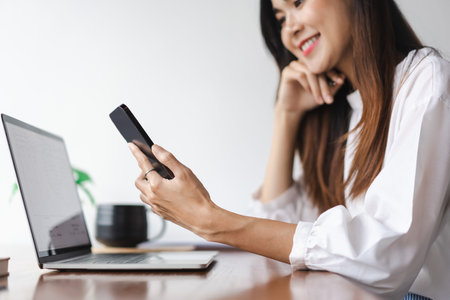 Businesswomen read data on smartphone to thinking about new startup while working in outside office.の写真素材