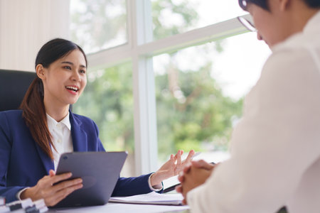 Lawyer woman use tablet and explaining about business contract and legal agreement with businessman.の写真素材
