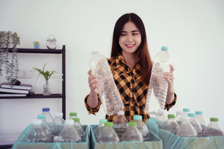 Women holding plastic bottle and putting in box to reuse and recycling for sustainable environment.