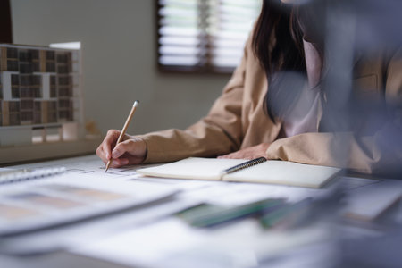 Female architect work to designing architecture interior and drawing building project on blueprint.の写真素材