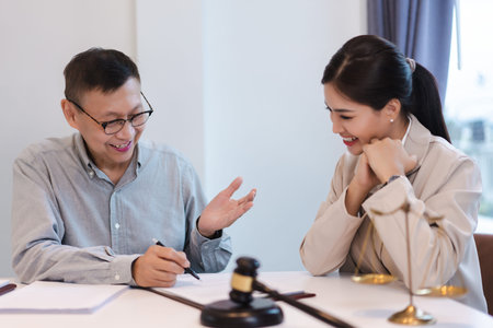 Senior lawyer explaining term of contract with legal agreement and asking data with businesswoman.