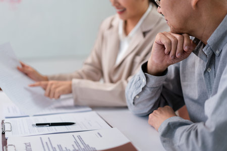 Female lawyer explaining terms of business contract with legal agreement to senior businessman.の写真素材