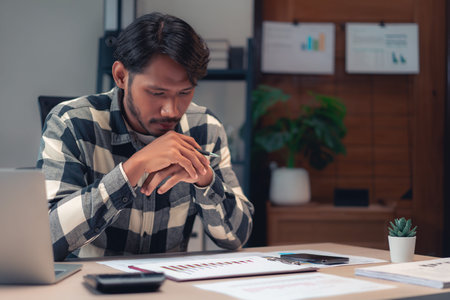 Businessman reading financial and accounting report to thinking about strategy and plan of business.の写真素材