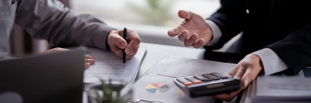 Two businessman real estate seller calculating about property investment and showing statistic on...