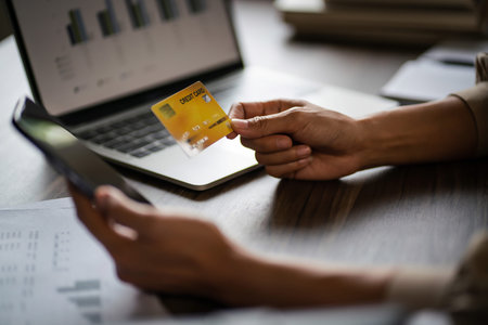 Female entrepreneur hold credit card to shopping online on smartphone and working about new startup.