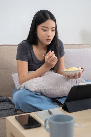Young asian women watching movie entertainment and social media on digital tablet with happiness...