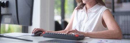 Asian businesswomen use computer to reading marketing report and typing data on keyboard to...