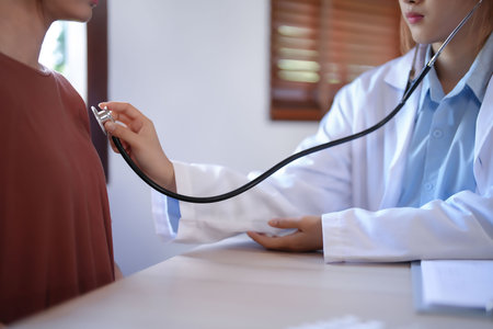 Asian psychologist women use stethoscope to examining heartbeat of patient and giving counseling about mental health therapy while female patient stress and anxiety with psychological health problem.の写真素材